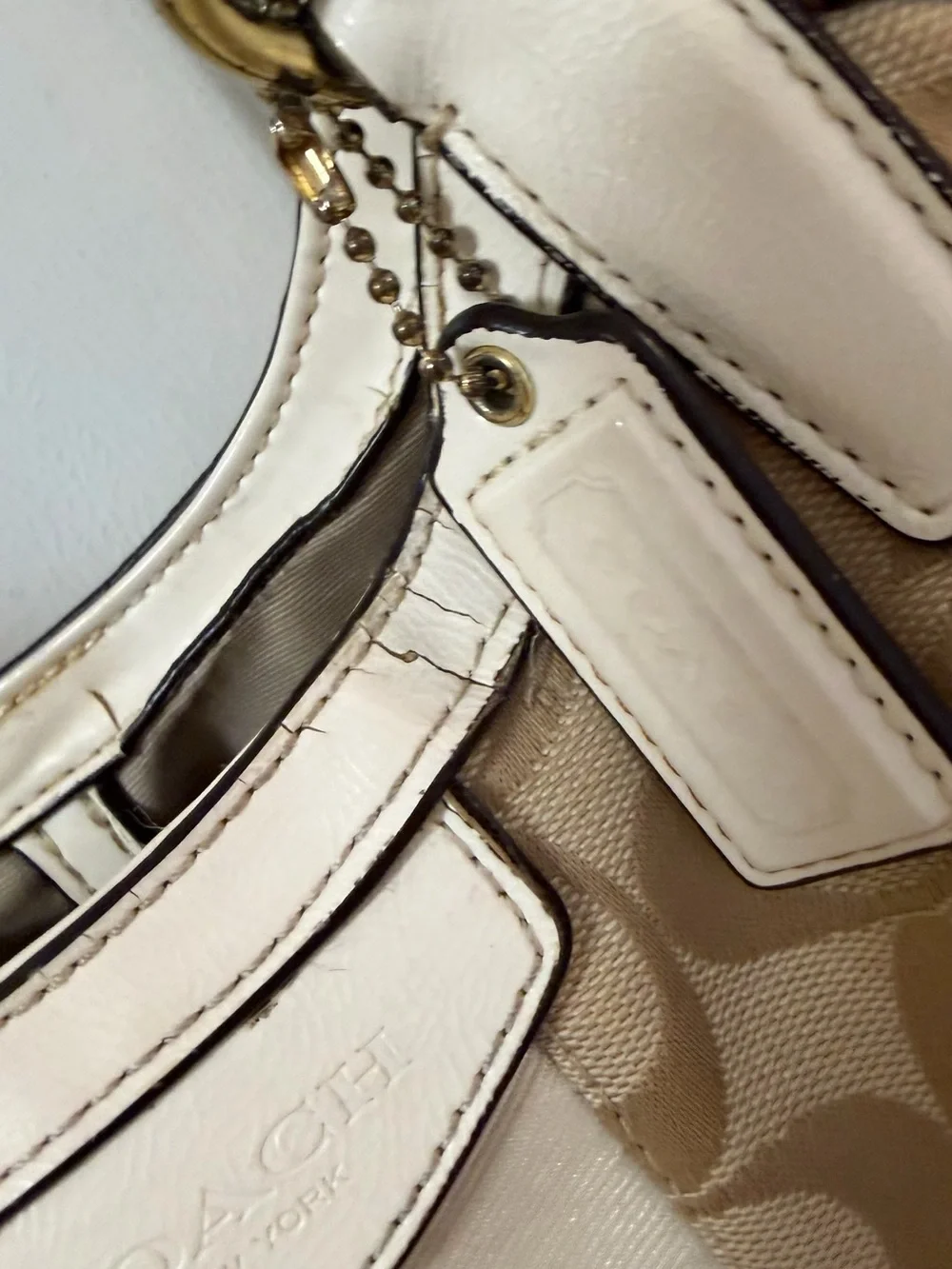 Coach Signature Canvas Beige Tote Bag with Ivory Trim handles are cracked!